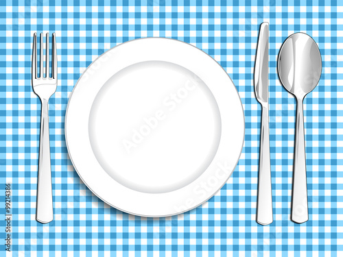 Plate setting white blue checkered tablecloth spoon and fork