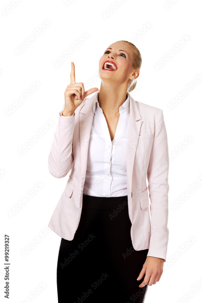 Young smiling business woman pointing up Young smiling business woman pointing up