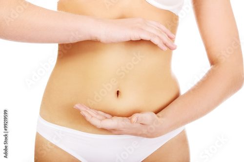 Slim woman belly with hand on it
