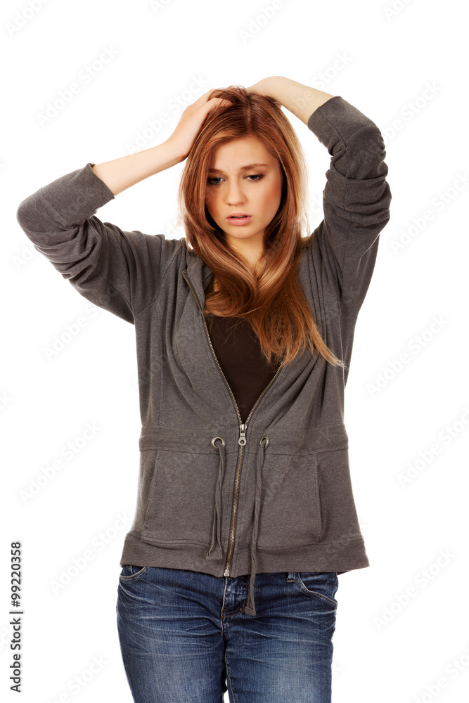 Teen woman with headache holding her hand to the head Teen woman with headache holding her hand to the head