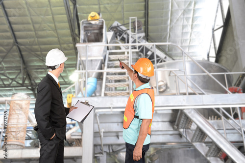 Engineer and supervisors are checking manufacturing.