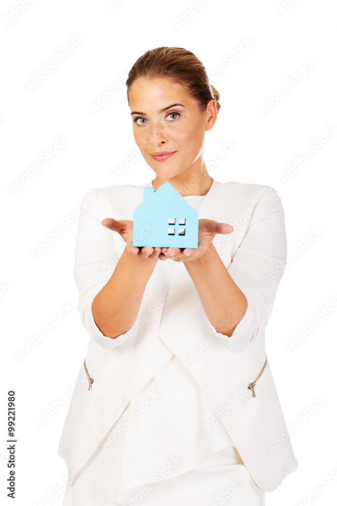 Smile businesswoman holding a paper house Smile businesswoman holding a paper house