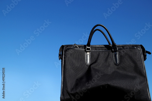 black business bag in the blue sky © Naoki Kim