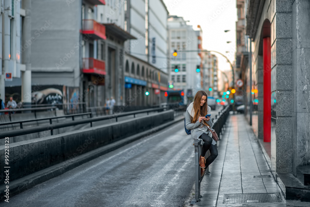 Woman with phone in the city