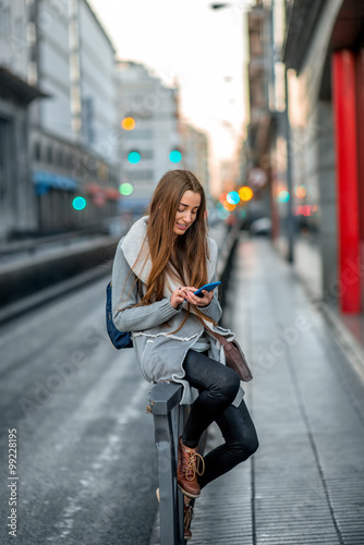 Woman with phone in the city