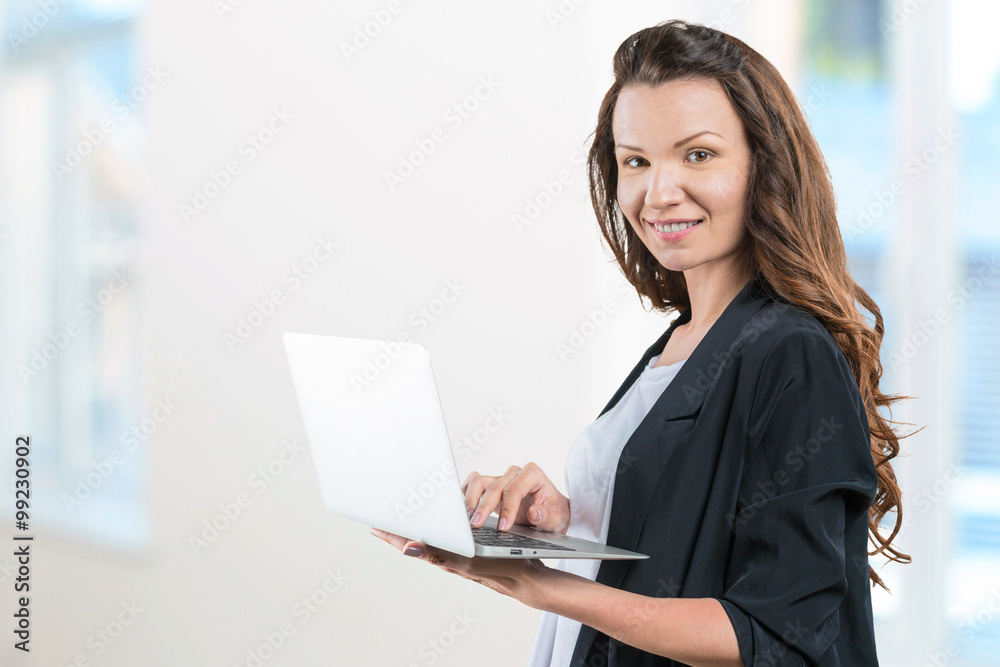 Portrait of young beautiful brunnete woman holding laptop Portrait of young beautiful brunnete woman holding laptop