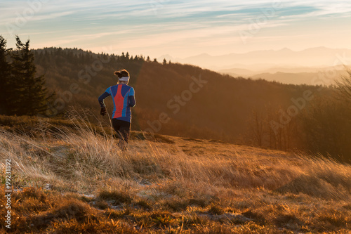 woman running alone in the mountains in the morning