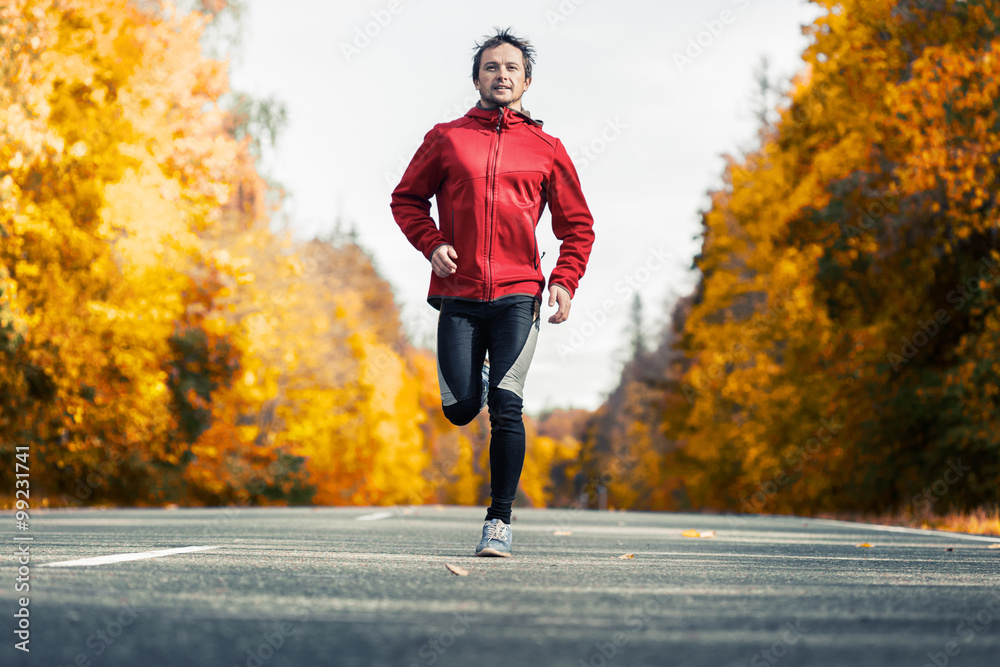Runner on the autumn road