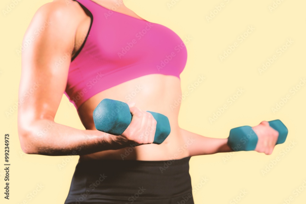 Composite image of muscular woman lifting heavy dumbbells Composite image of muscular woman lifting heavy dumbbells