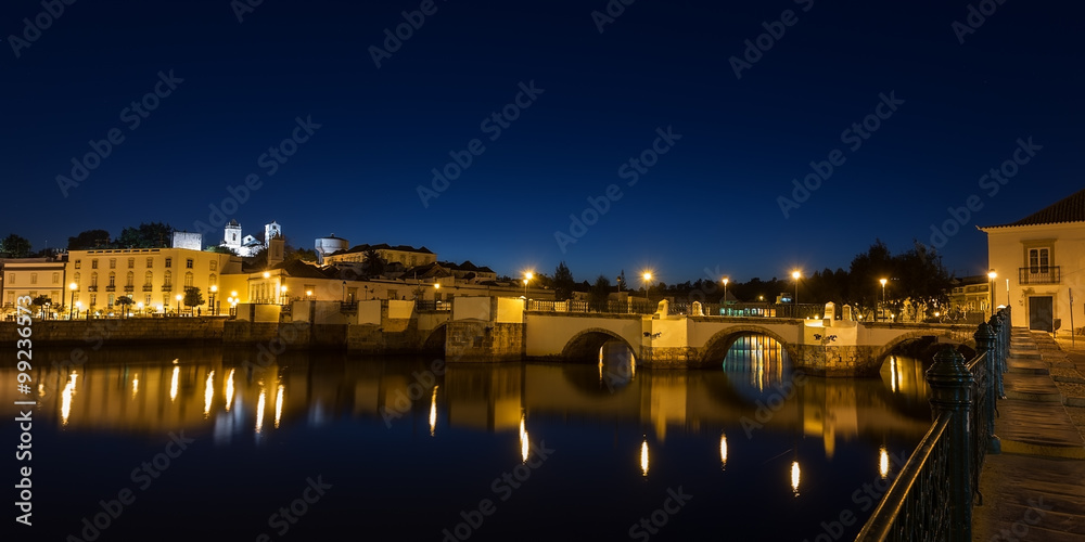 Panorama of the night city of Tavira. Roman bridge. in Portugal