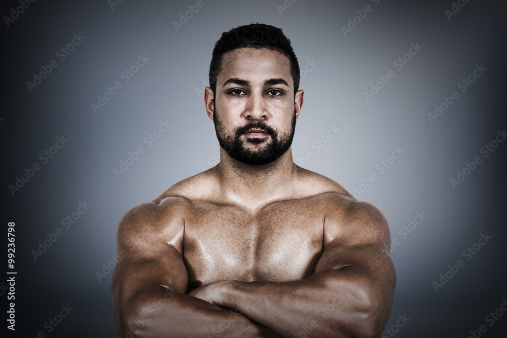 Composite image of muscular man flexing for camera Composite image of muscular man flexing for camera