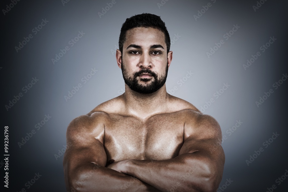 Composite image of muscular man flexing for camera