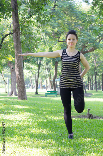 Portrait of thai adult beautiful girl doing yoga exercises in the park