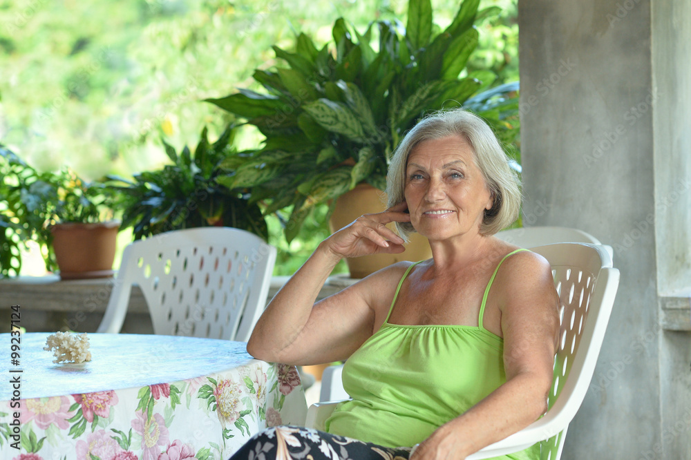 Fototapeta premium Older woman resting at tropical resort