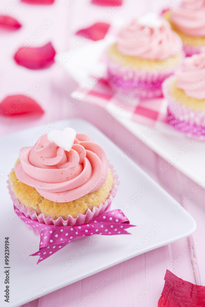 Pink Valentine cupcakes on a rustic pink table Pink Valentine cupcakes on a rustic pink table