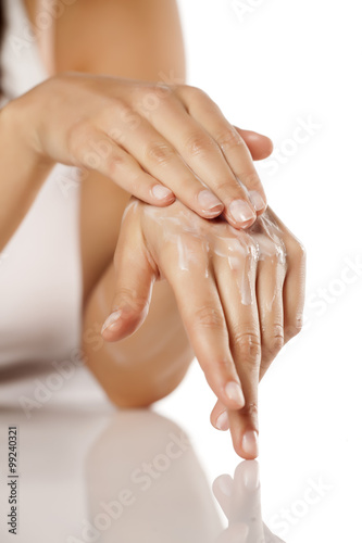 Woman applying hand cream