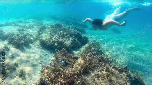 Young woman dives in beautiful blue sea in slow motion, Slow Motion Video clip