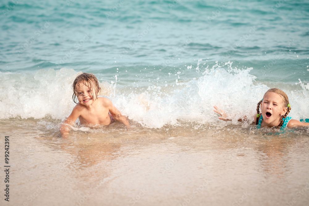Two happy children playing on the beach Two happy children playing on the beach