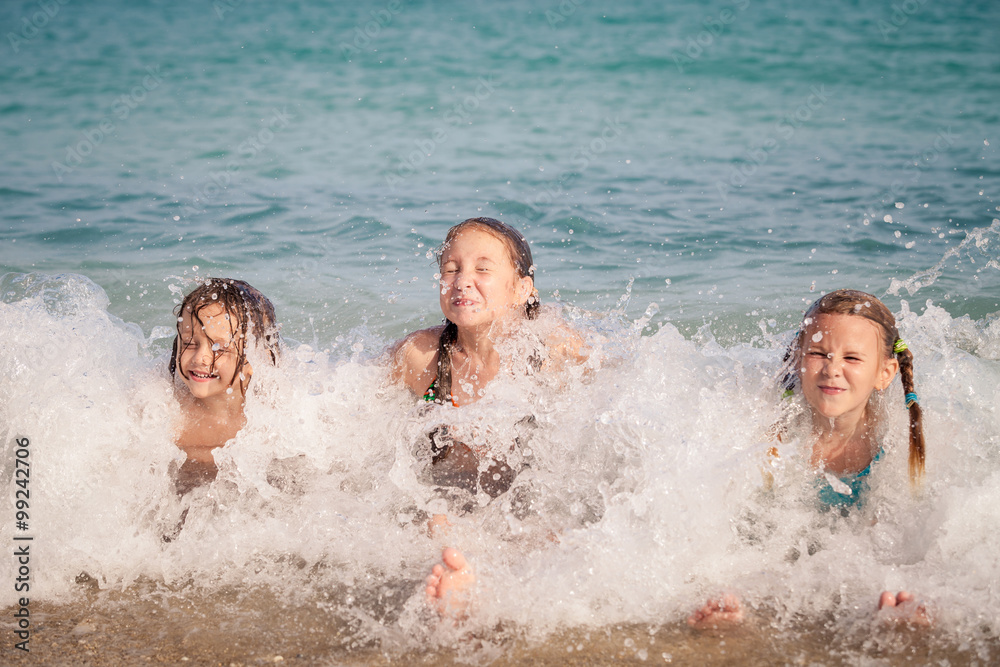 Three happy children playing on the beach Three happy children playing on the beach