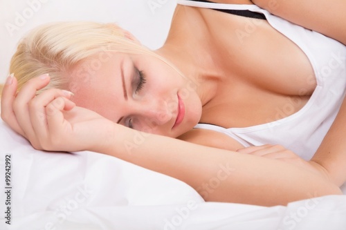 Blonde girl sleeping in bed