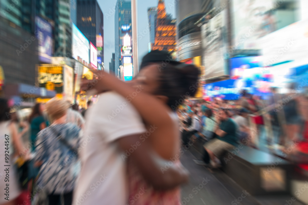 Blurred view of couple embracing at Times Square, New York City