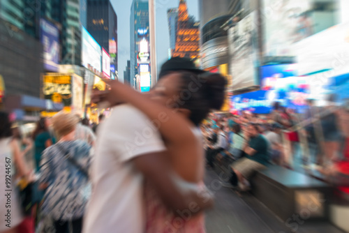 Blurred view of couple embracing at Times Square, New York City