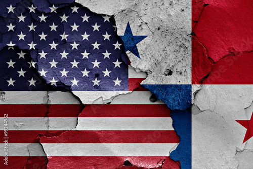 flags of USA and Panama painted on cracked wall
