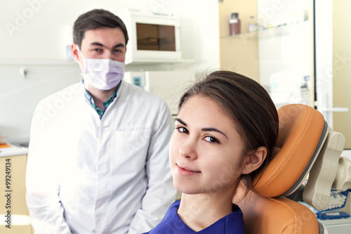 A dentist in a dental clinic. Girl smiling