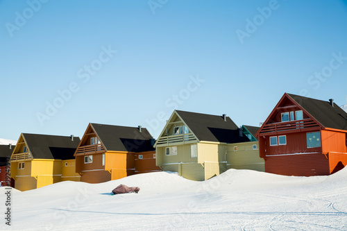 LONGYEARBYEN, SPITSBERGEN, NORWAY - APRIL 03, 2015: A small town in the far north of Europe among the snow-capped mountains.