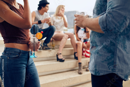 Young people having rooftop cocktail party