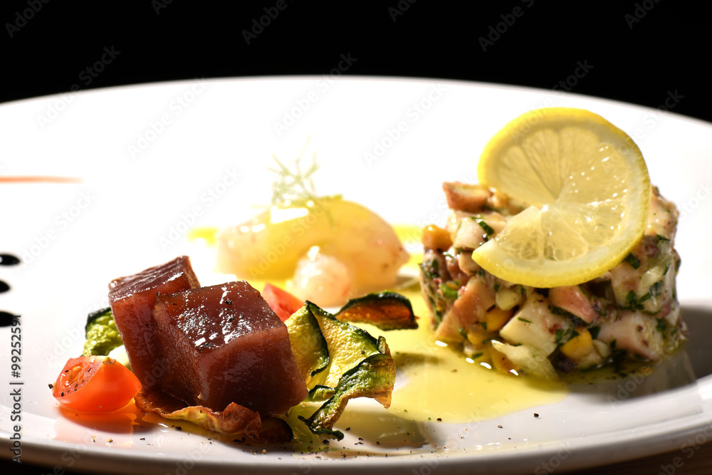 Fine dining seafood appetizer with Tuna Sashimi, octopus salad and shrimps Fine dining seafood appetizer with Tuna Sashimi, octopus salad and shrimps