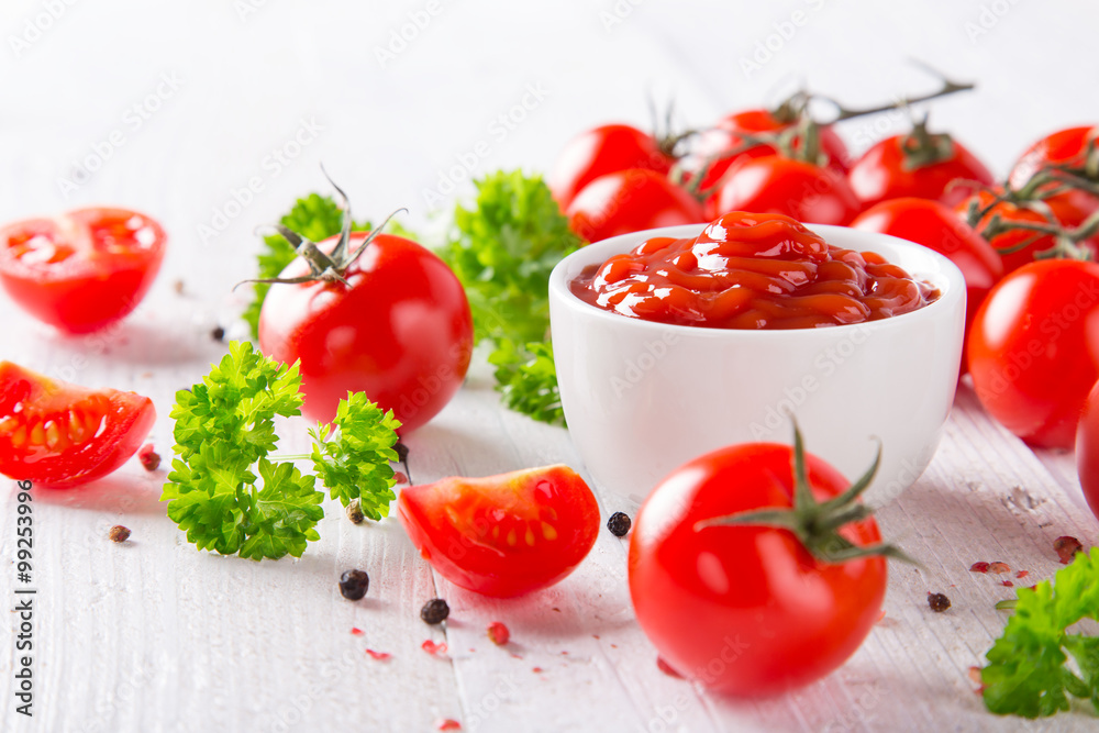 Bowl of tomato sauce and cherry tomatoes on wooden table. Bowl of tomato sauce and cherry tomatoes on wooden table.