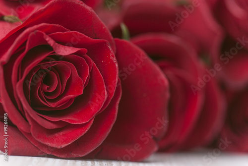 Red roses and a heart on wooden board  Valentines Day background  wedding day