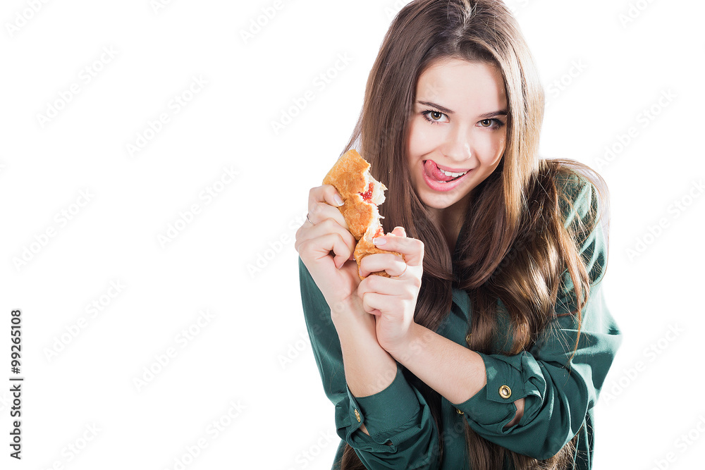 attractive brunette woman eating a croissant on isolated background.