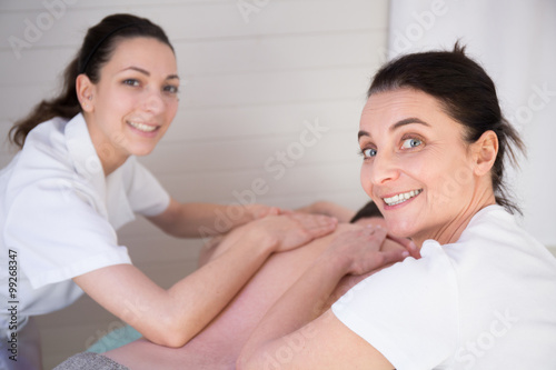 wellness massage in the spa salon make four hands photo