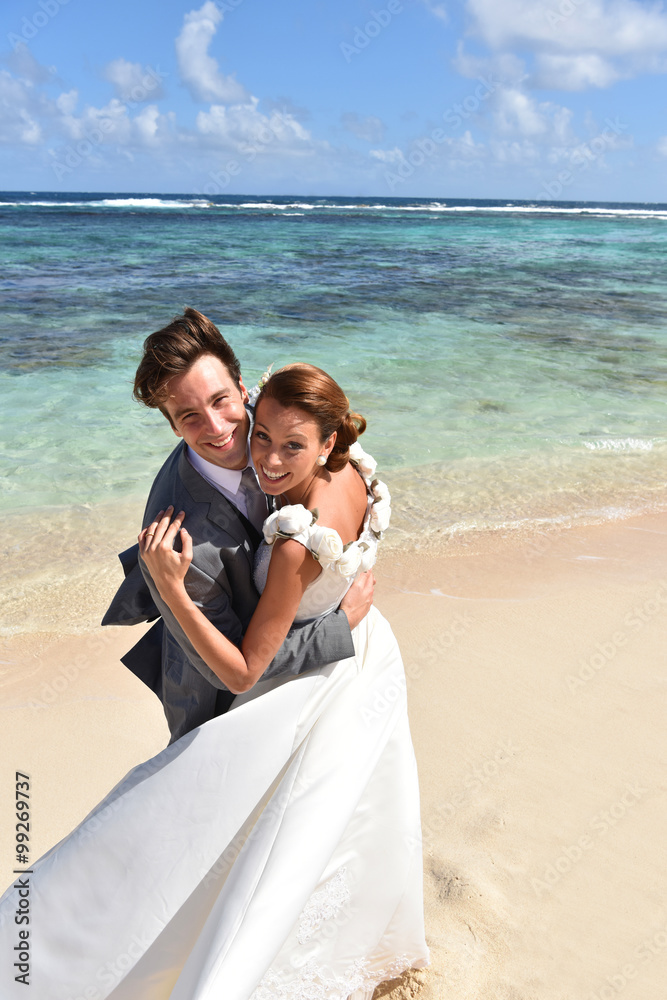 Romantic couple celebrating wedding on a sandy beach Romantic couple celebrating wedding on a sandy beach