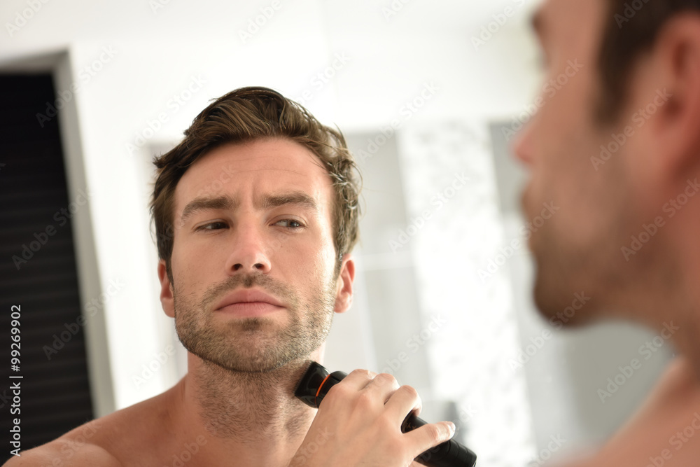 Ταπετσαρία Handsome man in bathroom shaving with electric razor