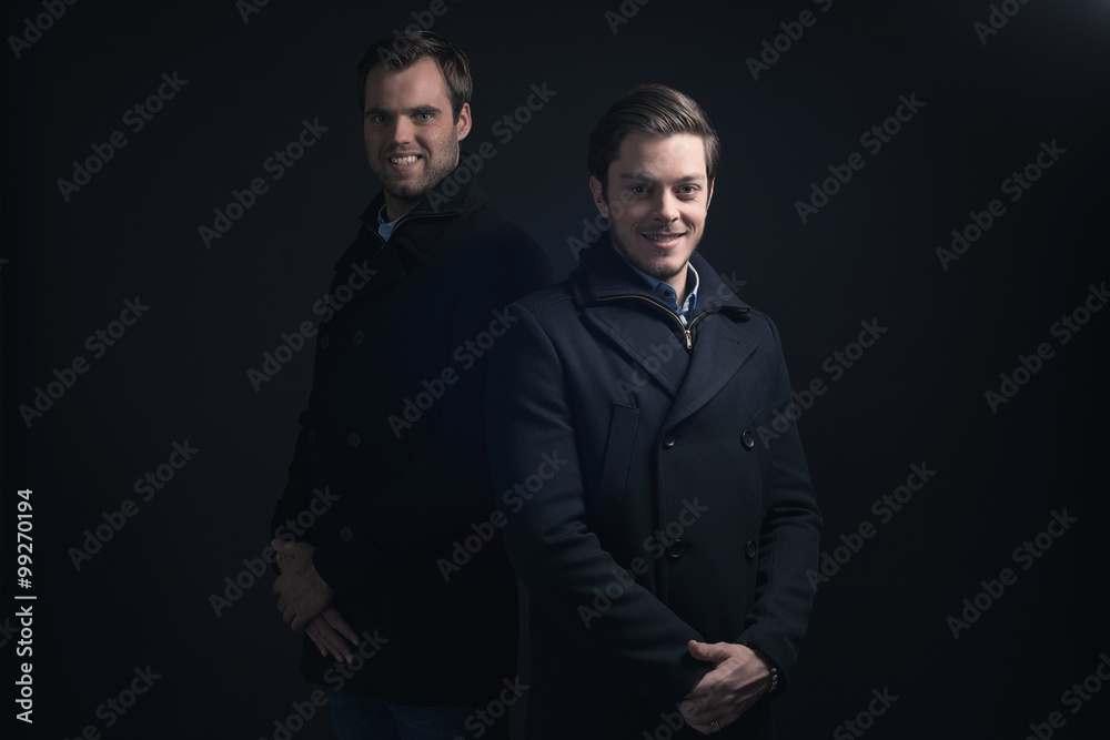 Two men in dark blue winter coat.