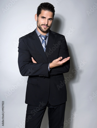 handsome young man in suit on grey background. Business man