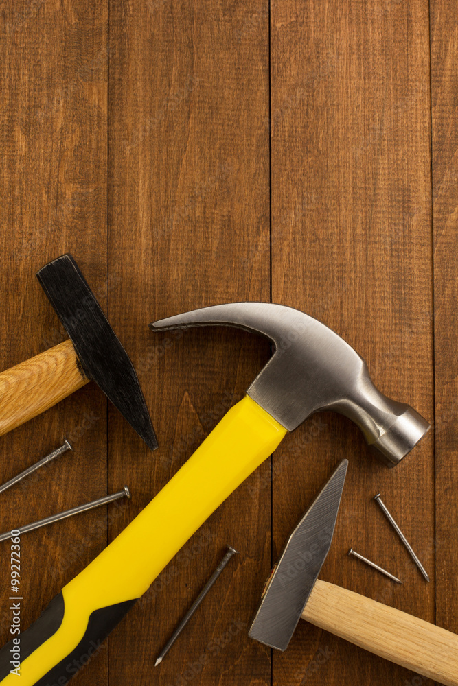 hammer tool and nail on wood