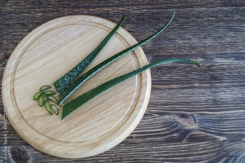 Aloe vera fresh leaf on the cutting board, on wooden background. Aloe vera fresh leaf on the cutting board, on wooden background.