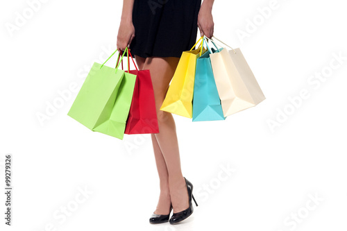 young woman holding colored shopping bags