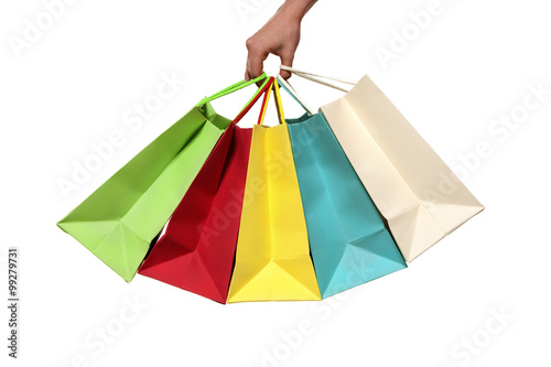 Hand holding colorful shopping bags - isolated