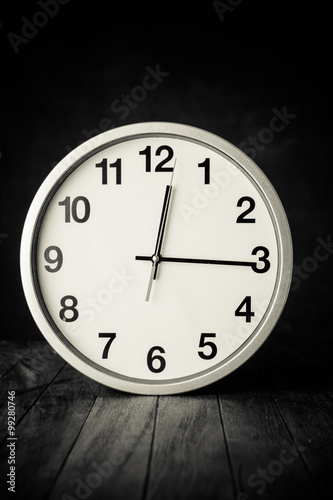 white clock on a table with old steel background,black and white