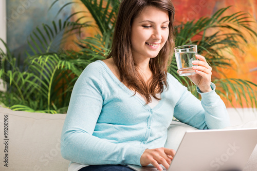 Girl quenching thirst with water photo