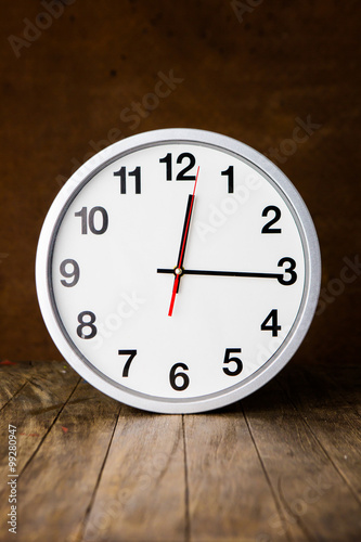 white clock on a table with old steel background,vintage style