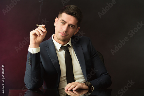 Boss with smirk smoking cigarette