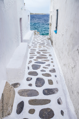 Fototapeta Naklejka Na Ścianę i Meble -  Traditional whitewashed alley of Mykonos with seaview, Greece