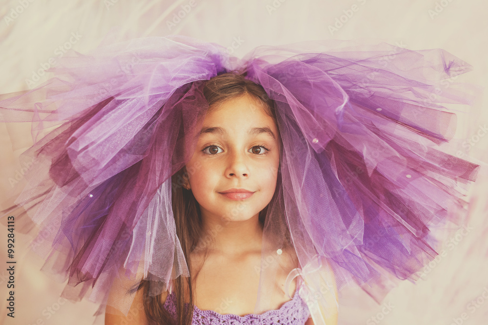 Girl dressed in purple with a funny hat Girl dressed in purple with a funny hat