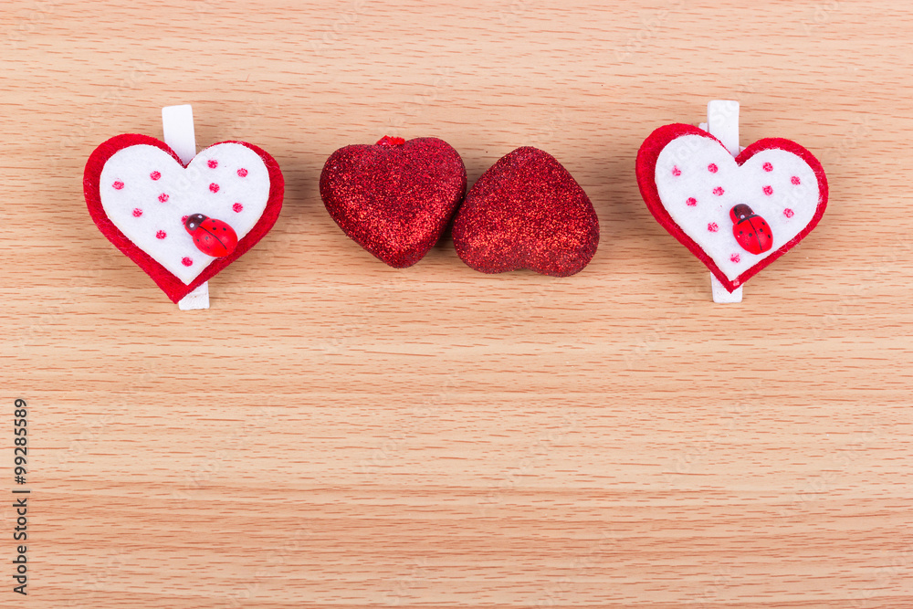 Four hearts on a light wooden background Four hearts on a light wooden background
